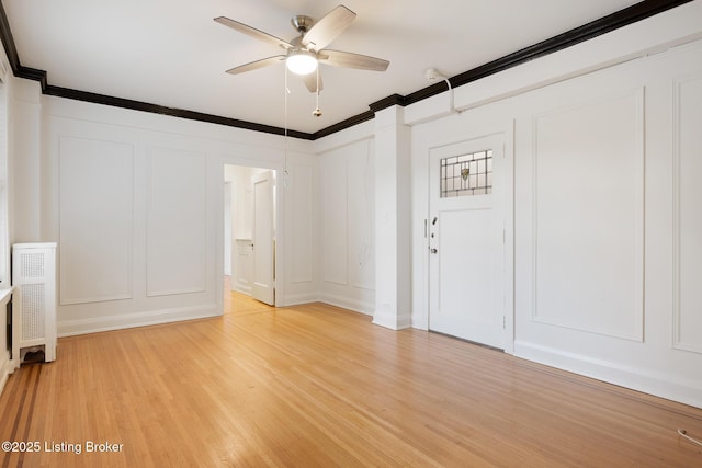 1412 Willow Ave Unit 56, Louisville, KY 40204 - empty room with a decorative wall, crown molding, light wood-type flooring, and ceiling fan