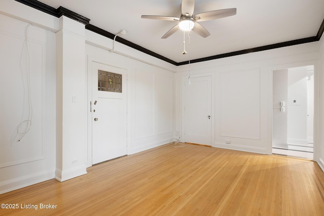 1412 Willow Ave Unit 56, Louisville, KY 40204 - spare room featuring light wood-style flooring, a ceiling fan, and crown molding