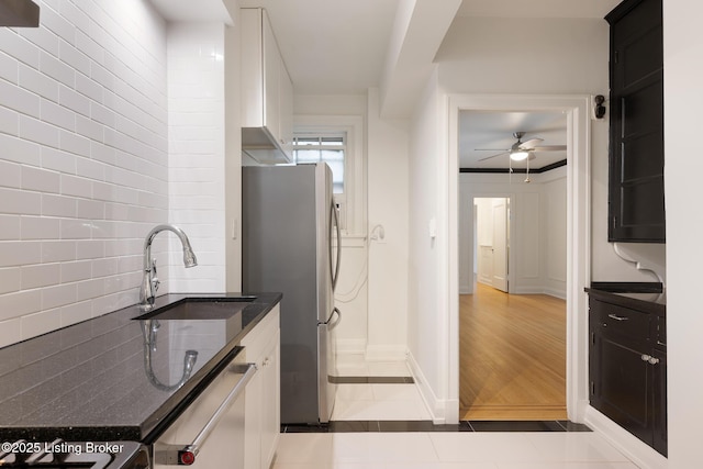 1412 Willow Ave Unit 56, Louisville, KY 40204 - kitchen featuring appliances with stainless steel finishes, a ceiling fan, tile patterned flooring, dark stone counters, and tasteful backsplash