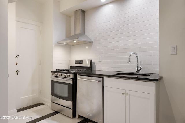 1412 Willow Ave Unit 56, Louisville, KY 40204 - kitchen with wall chimney exhaust hood, stainless steel appliances, decorative backsplash, and dark countertops