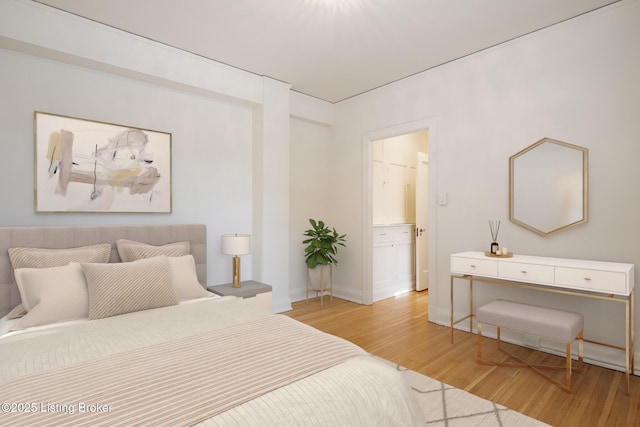 1412 Willow Ave Unit 56, Louisville, KY 40204 - bedroom with light wood-style flooring and ensuite bath