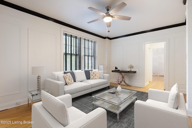 1412 Willow Ave Unit 56, Louisville, KY 40204 - living area featuring a decorative wall, crown molding, ceiling fan, and light wood-style flooring