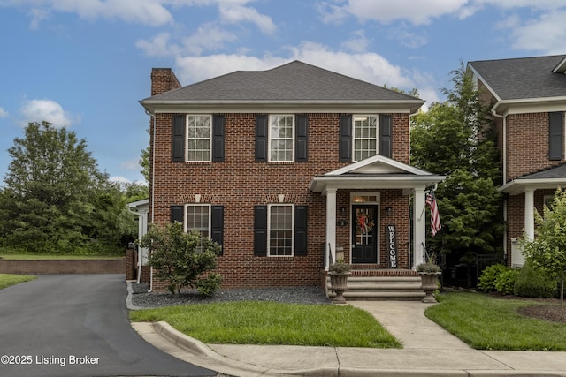 895 Woodlawn Rd Unit 3, Bardstown, KY 40004 - view of front of home with a chimney, brick siding, a shingled roof, and a front lawn