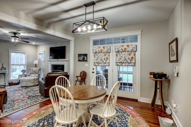 895 Woodlawn Rd Unit 3, Bardstown, KY 40004 - dining room with dark wood finished floors, a fireplace, a ceiling fan, a chandelier, and baseboards