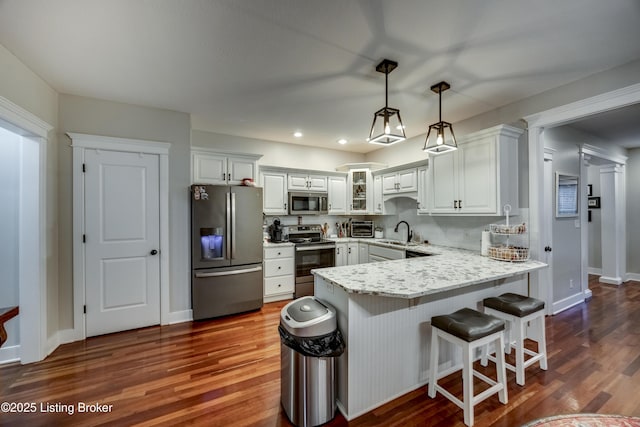 895 Woodlawn Rd Unit 3, Bardstown, KY 40004 - kitchen featuring appliances with stainless steel finishes, a sink, a peninsula, dark wood-type flooring, and recessed lighting