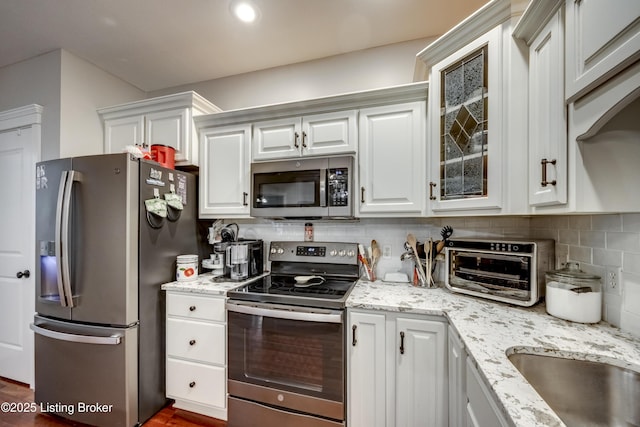 895 Woodlawn Rd Unit 3, Bardstown, KY 40004 - kitchen featuring stainless steel appliances, backsplash, white cabinets, light stone countertops, and glass insert cabinets