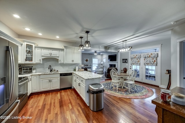895 Woodlawn Rd Unit 3, Bardstown, KY 40004 - kitchen featuring appliances with stainless steel finishes, a sink, a peninsula, wood finished floors, and open floor plan