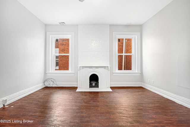 1033 S Brook St, Louisville, KY 40203 - unfurnished living room with wood finished floors, baseboards, and healthy amount of natural light