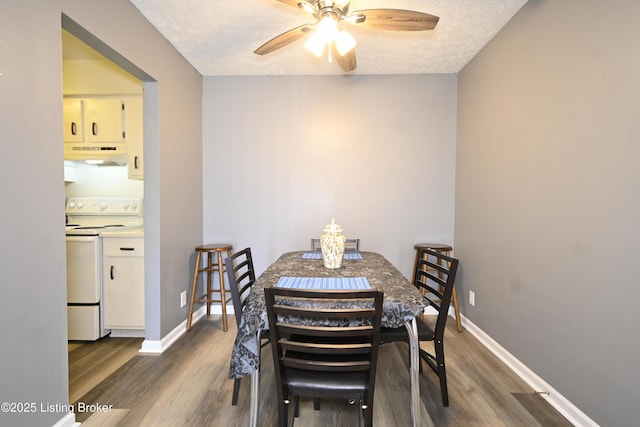 7050 Wildwood Cir Unit 100, Louisville, KY 40291 - dining room with wood finished floors, a ceiling fan, and a textured ceiling