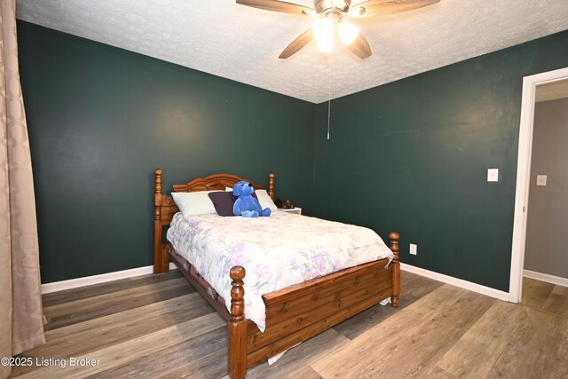 7050 Wildwood Cir Unit 100, Louisville, KY 40291 - bedroom featuring a textured ceiling, wood finished floors, and ceiling fan