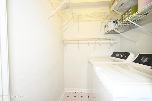 7050 Wildwood Cir Unit 100, Louisville, KY 40291 - laundry room with washing machine and dryer and baseboards