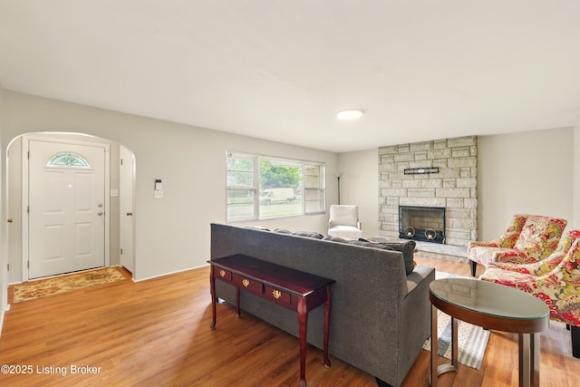 1212 Hibiscus Dr, Clarksville, IN 47129 - living room featuring light wood finished floors, arched walkways, and a fireplace