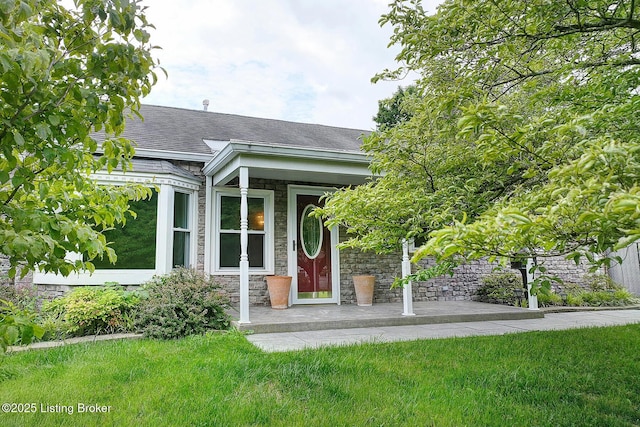 3116 Osprey Rd, Louisville, KY 40213 - view of exterior entry with stone siding, roof with shingles, and a lawn