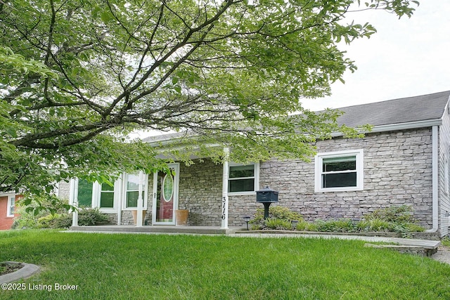 3116 Osprey Rd, Louisville, KY 40213 - view of front of home with stone siding, a front yard, and roof with shingles