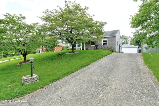 3116 Osprey Rd, Louisville, KY 40213 - view of front of home featuring stone siding, a front lawn, a garage, and an outbuilding