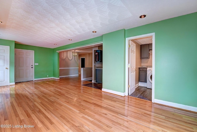 3116 Osprey Rd, Louisville, KY 40213 - unfurnished living room with washer / dryer and light wood-style floors