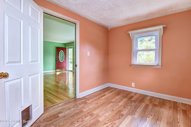 3116 Osprey Rd, Louisville, KY 40213 - empty room with light wood finished floors, crown molding, and a textured ceiling