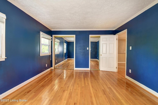 3116 Osprey Rd, Louisville, KY 40213 - unfurnished bedroom featuring a textured ceiling, wood-type flooring, crown molding, and two closets