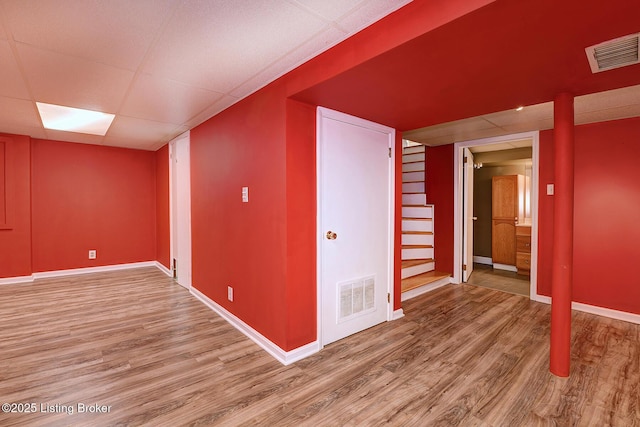 3116 Osprey Rd, Louisville, KY 40213 - finished below grade area featuring wood finished floors, stairway, and a paneled ceiling