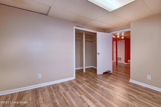 3116 Osprey Rd, Louisville, KY 40213 - unfurnished bedroom featuring light wood-type flooring, a paneled ceiling, and a closet