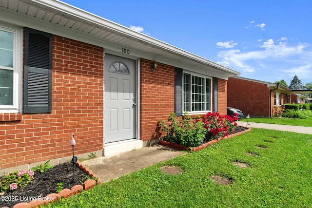 180 Valley Rd, Louisville, KY 40229 - doorway to property with a lawn and brick siding
