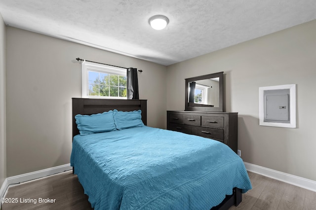 180 Valley Rd, Louisville, KY 40229 - bedroom with baseboards, electric panel, wood finished floors, and a textured ceiling