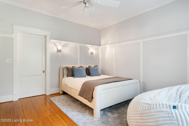 11106 Beech Rd, Anchorage, KY 40223 - bedroom with a decorative wall, wood finished floors, ornamental molding, wainscoting, and a ceiling fan