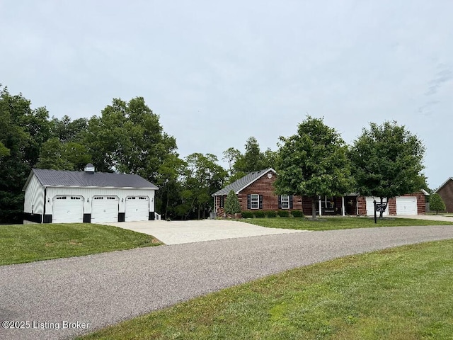 218 Woebegona Way, Hodgenville, KY 42748 - view of front of house featuring a front yard, concrete driveway, and an outbuilding