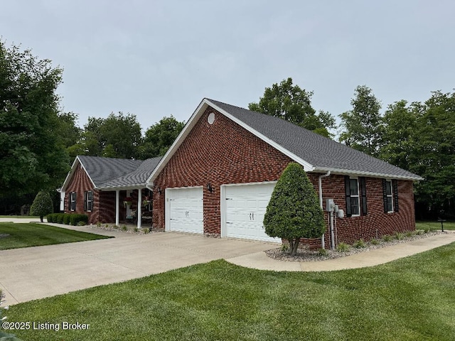 218 Woebegona Way, Hodgenville, KY 42748 - view of home's exterior featuring a yard, brick siding, driveway, a garage, and a shingled roof