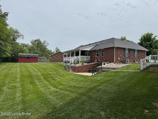 218 Woebegona Way, Hodgenville, KY 42748 - back of house featuring stairs, cooling unit, and a yard