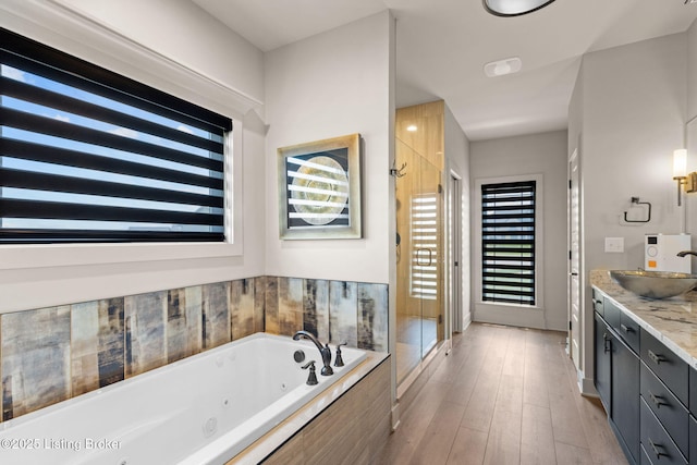 6299 Clore Ln, Crestwood, KY 40014 - full bathroom with vanity, a shower stall, a jetted tub, and wood finished floors