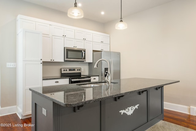 948 Samuel St, Louisville, KY 40204 - kitchen with stainless steel appliances, a kitchen breakfast bar, white cabinetry, decorative light fixtures, and recessed lighting