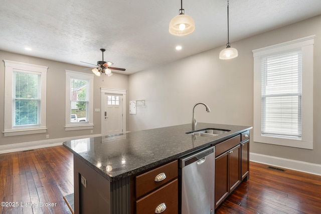 948 Samuel St, Louisville, KY 40204 - kitchen with dishwasher, a ceiling fan, dark wood-style flooring, hanging light fixtures, and an island with sink
