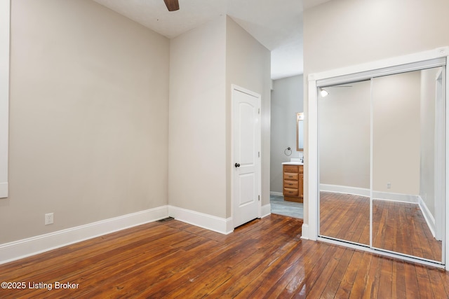 948 Samuel St, Louisville, KY 40204 - unfurnished bedroom featuring hardwood / wood-style flooring, a closet, and a ceiling fan