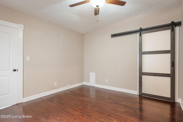 948 Samuel St, Louisville, KY 40204 - unfurnished bedroom featuring a barn door, hardwood / wood-style floors, and ceiling fan