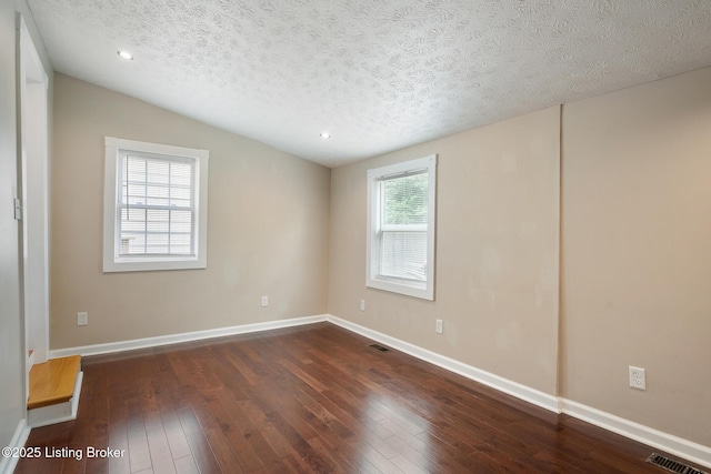 948 Samuel St, Louisville, KY 40204 - unfurnished room featuring vaulted ceiling, dark wood-style floors, a textured ceiling, and recessed lighting