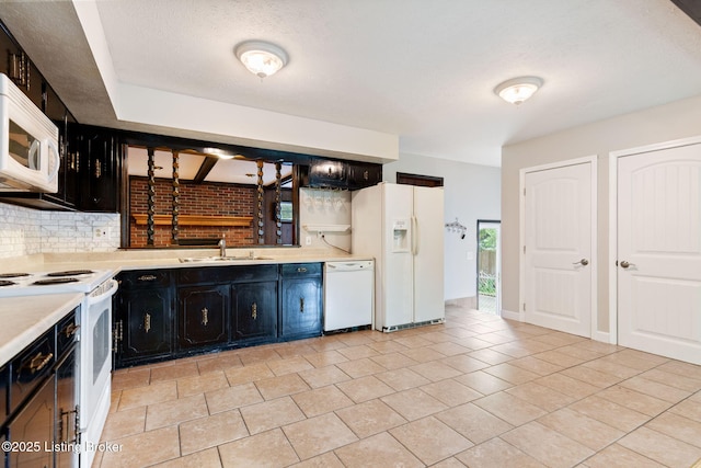 105 Daryl Ct, Louisville, KY 40214 - kitchen featuring white appliances, dark cabinetry, backsplash, light countertops, and light tile patterned floors