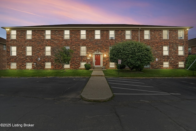 1007 Lake Pl Unit H11, Louisville, KY 40222 - view of front facade featuring brick siding, uncovered parking, and a front yard