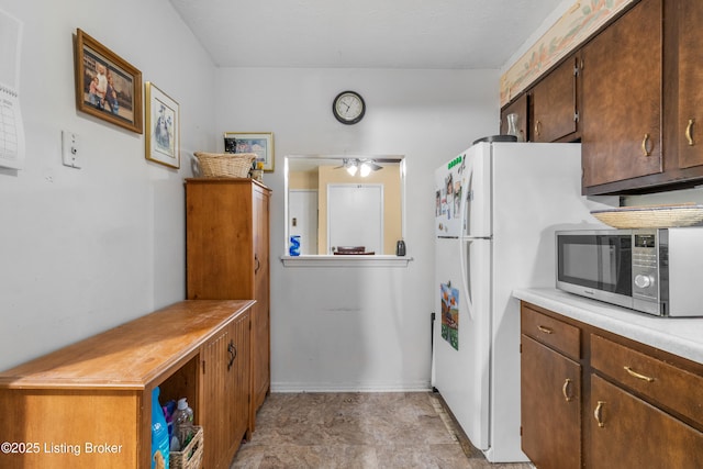 1007 Lake Pl Unit H11, Louisville, KY 40222 - kitchen with stainless steel microwave, light countertops, and ceiling fan