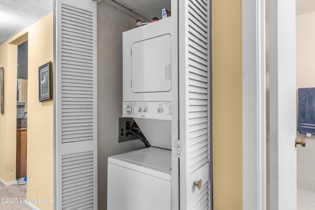 1007 Lake Pl Unit H11, Louisville, KY 40222 - laundry area featuring stacked washer and clothes dryer and baseboards