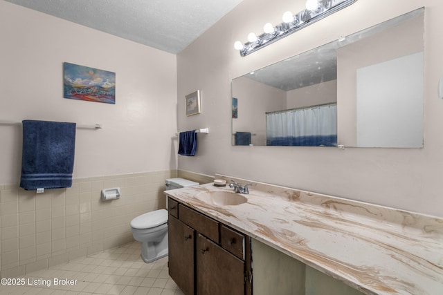 1007 Lake Pl Unit H11, Louisville, KY 40222 - full bathroom with tile walls, vanity, tile patterned flooring, a wainscoted wall, and a shower with curtain