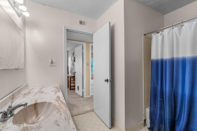 1007 Lake Pl Unit H11, Louisville, KY 40222 - bathroom with vanity, shower / bathtub combination with curtain, and a textured ceiling
