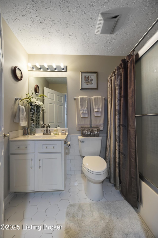 12582 Springfalls Ct, Louisville, KY 40229 - full bath featuring vanity, shower / bathtub combination with curtain, tile patterned flooring, and a textured ceiling