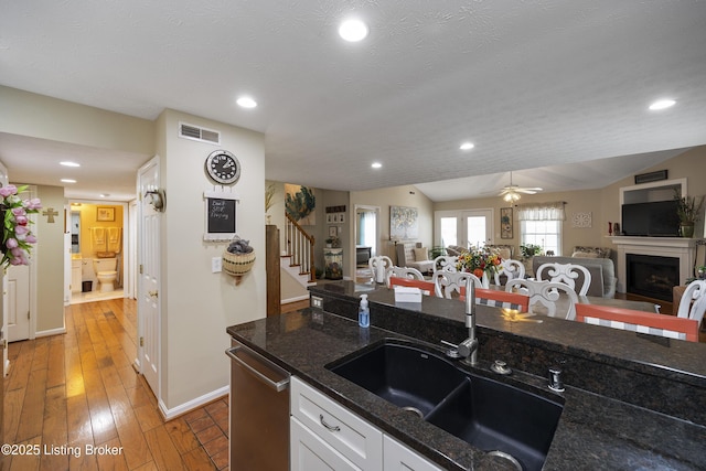 12582 Springfalls Ct, Louisville, KY 40229 - kitchen with open floor plan, dark stone counters, white cabinets, ceiling fan, and recessed lighting