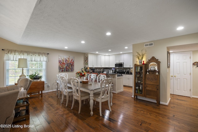12582 Springfalls Ct, Louisville, KY 40229 - dining room with a textured ceiling, dark wood-style floors, and recessed lighting