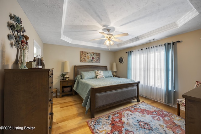 12582 Springfalls Ct, Louisville, KY 40229 - bedroom with a raised ceiling, light wood-type flooring, a textured ceiling, a ceiling fan, and ornamental molding
