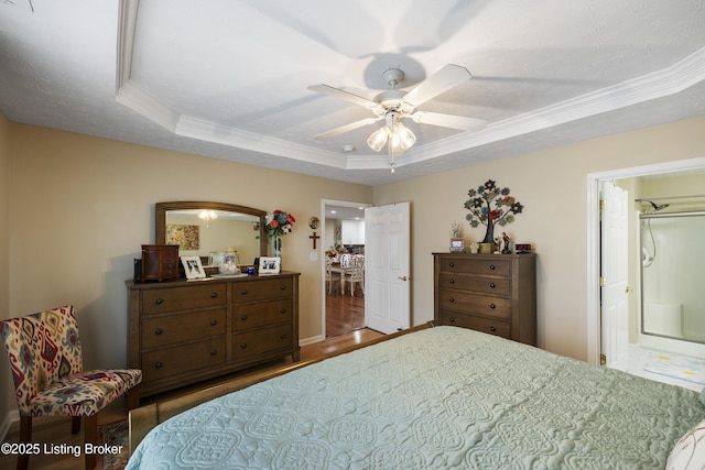 12582 Springfalls Ct, Louisville, KY 40229 - bedroom featuring a raised ceiling, wood finished floors, crown molding, a ceiling fan, and ensuite bath