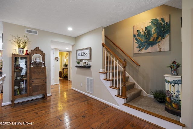 12582 Springfalls Ct, Louisville, KY 40229 - stairway featuring hardwood / wood-style floors and recessed lighting