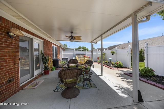 12582 Springfalls Ct, Louisville, KY 40229 - fenced backyard with a patio, ceiling fan, and outdoor dining space