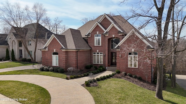 8705 Summit Ridge Dr, Louisville, KY 40241 - view of front of house with brick siding, a front yard, and roof with shingles